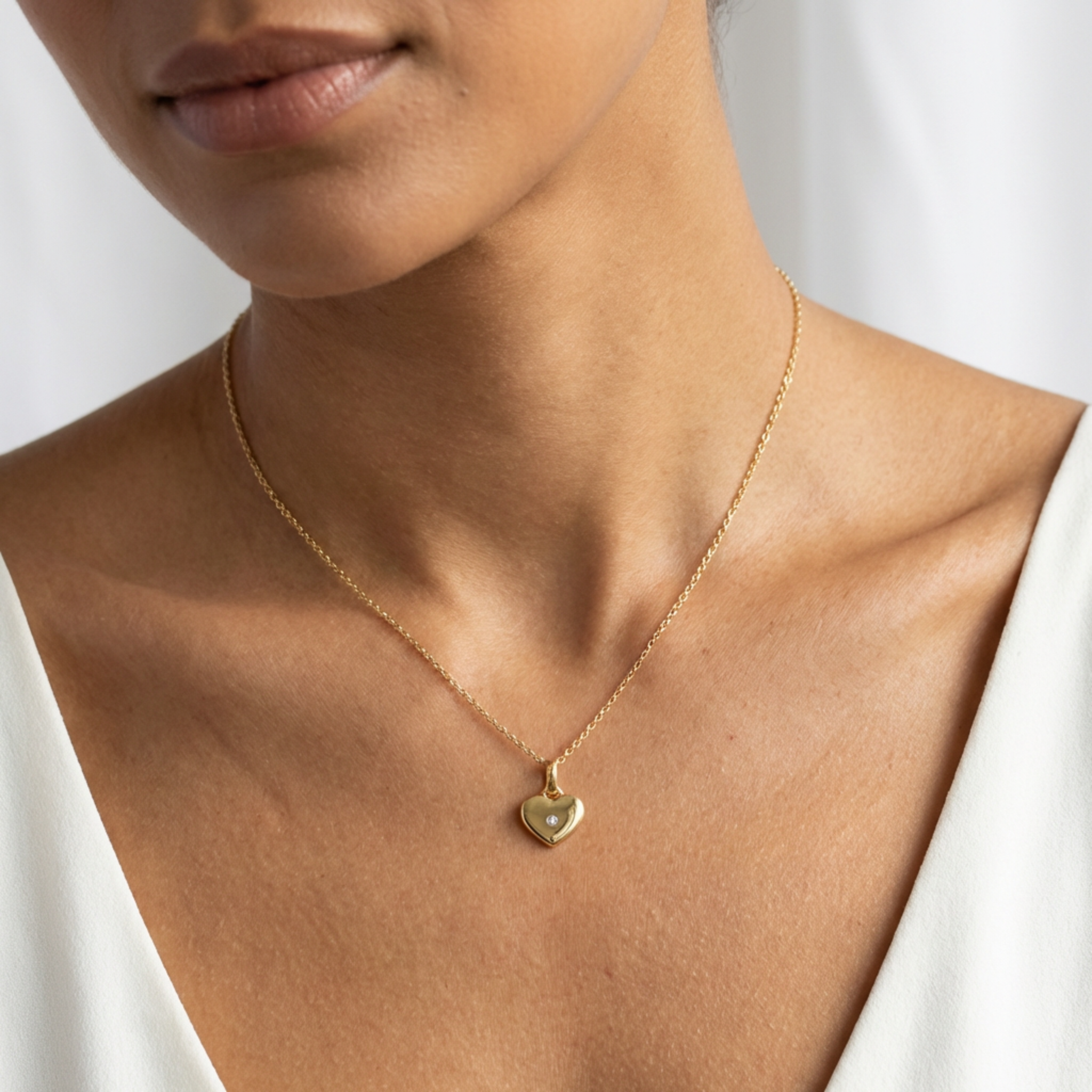 High polish 14k gold heart necklace with sparkling stone