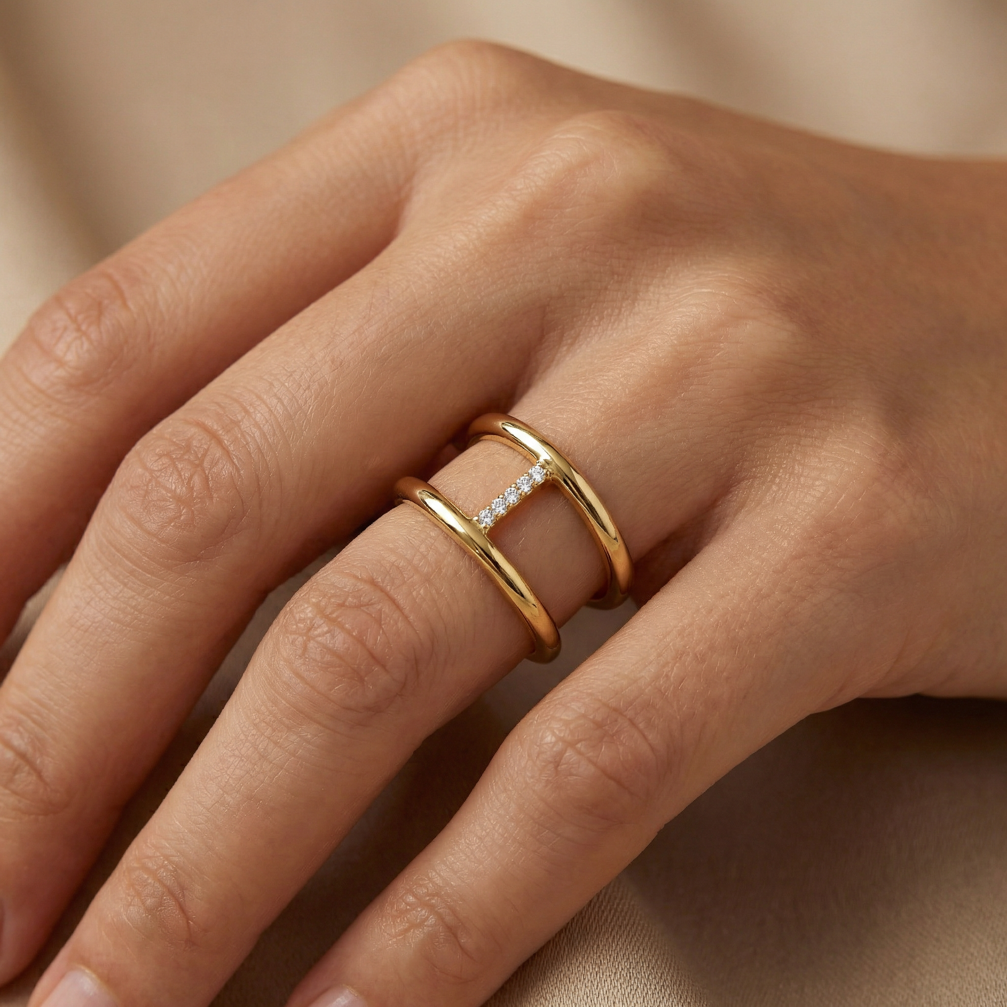 Close up of 14k yellow gold bar ring with pavé stones