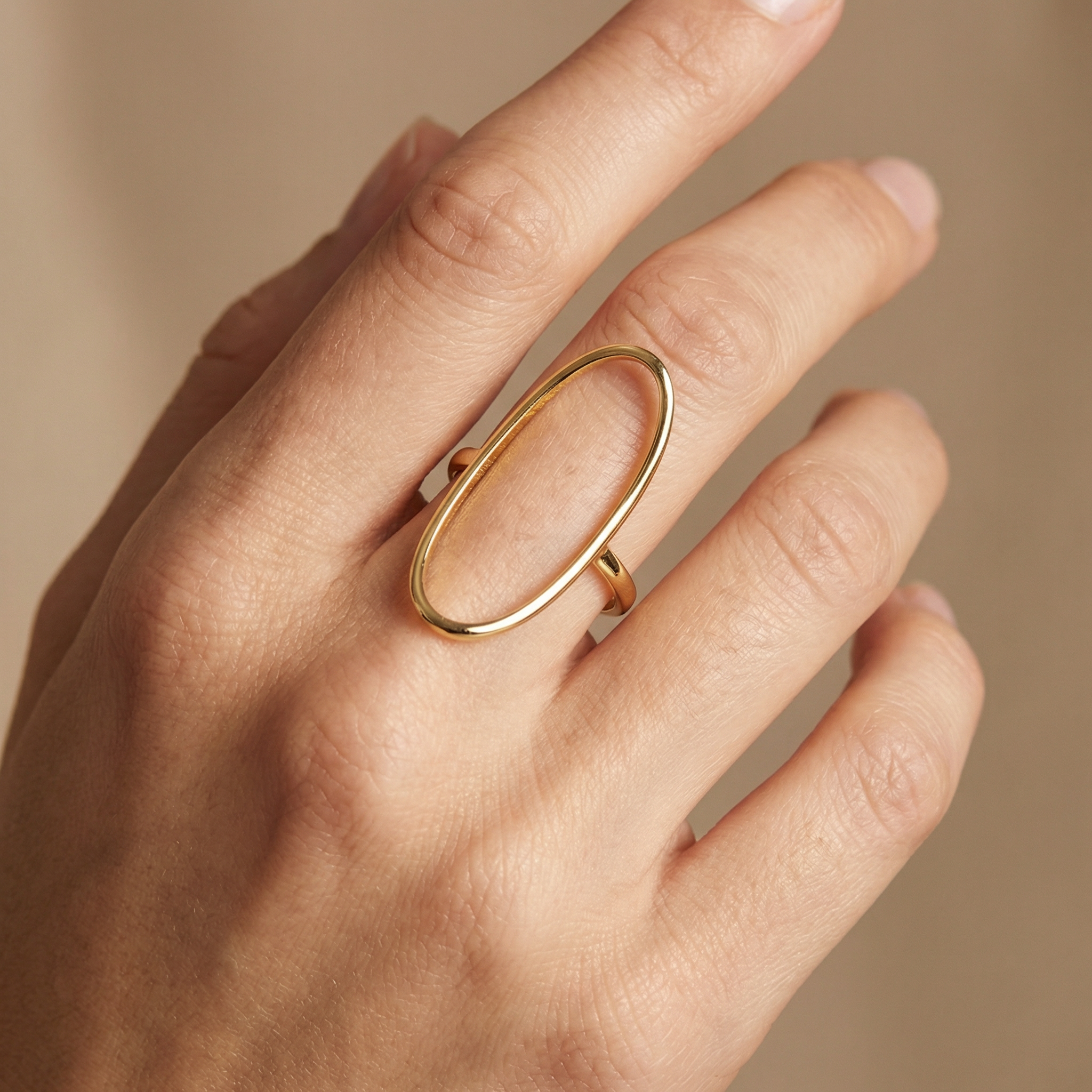 Dainty gold outline ring in elongated oval shape