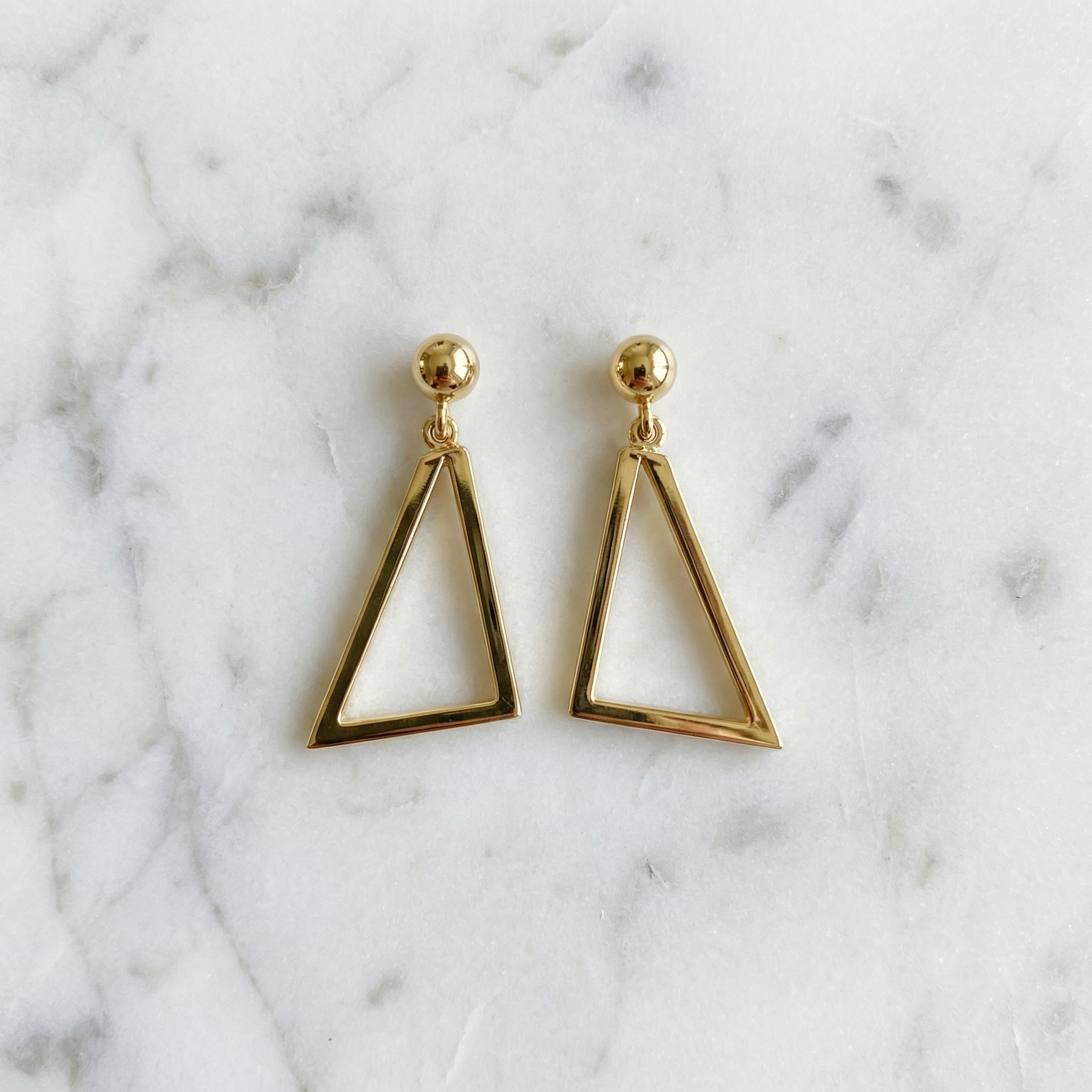 Modern geometric triangle dangle earrings in yellow gold