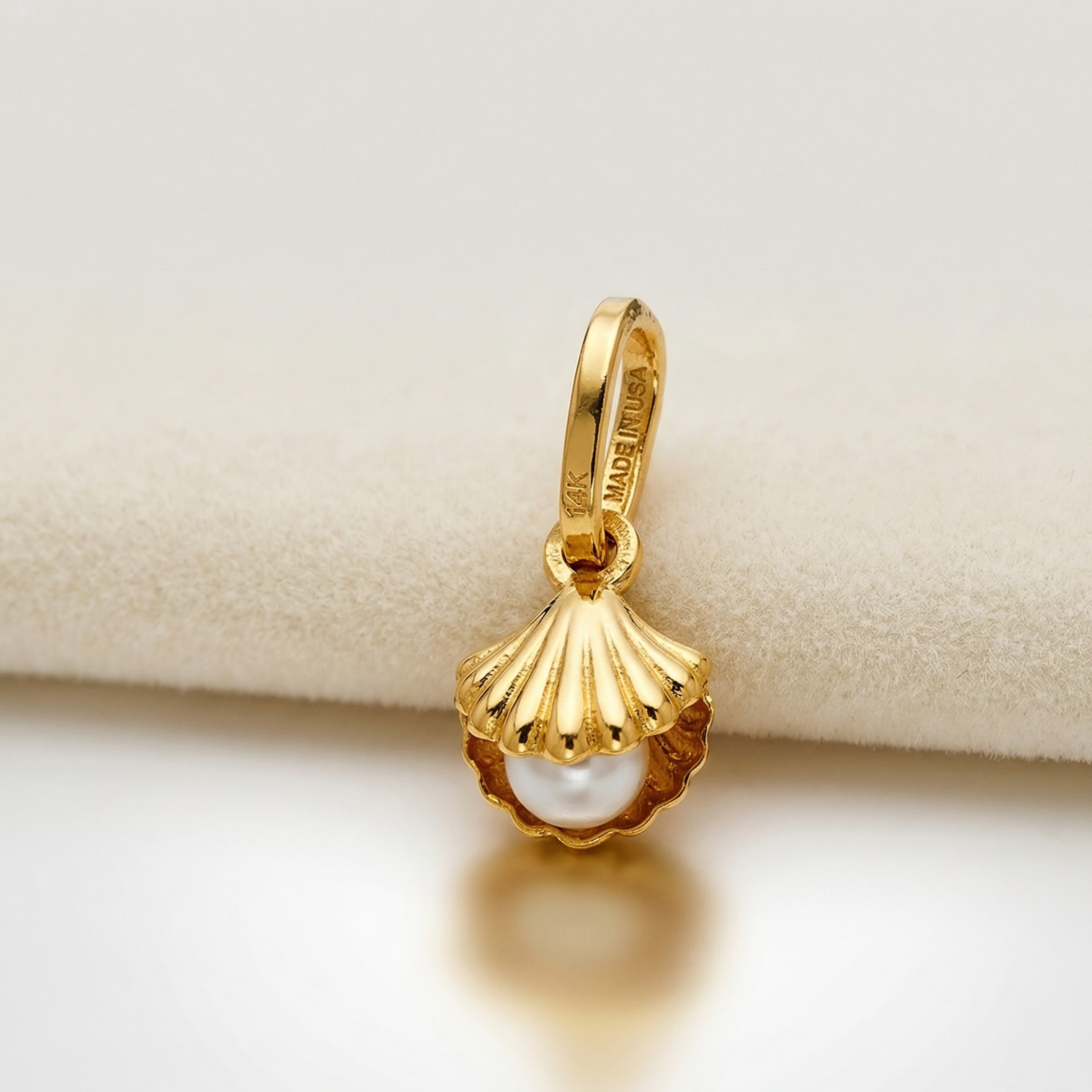High-polish 14k gold marine charm with shimmering pearl detail