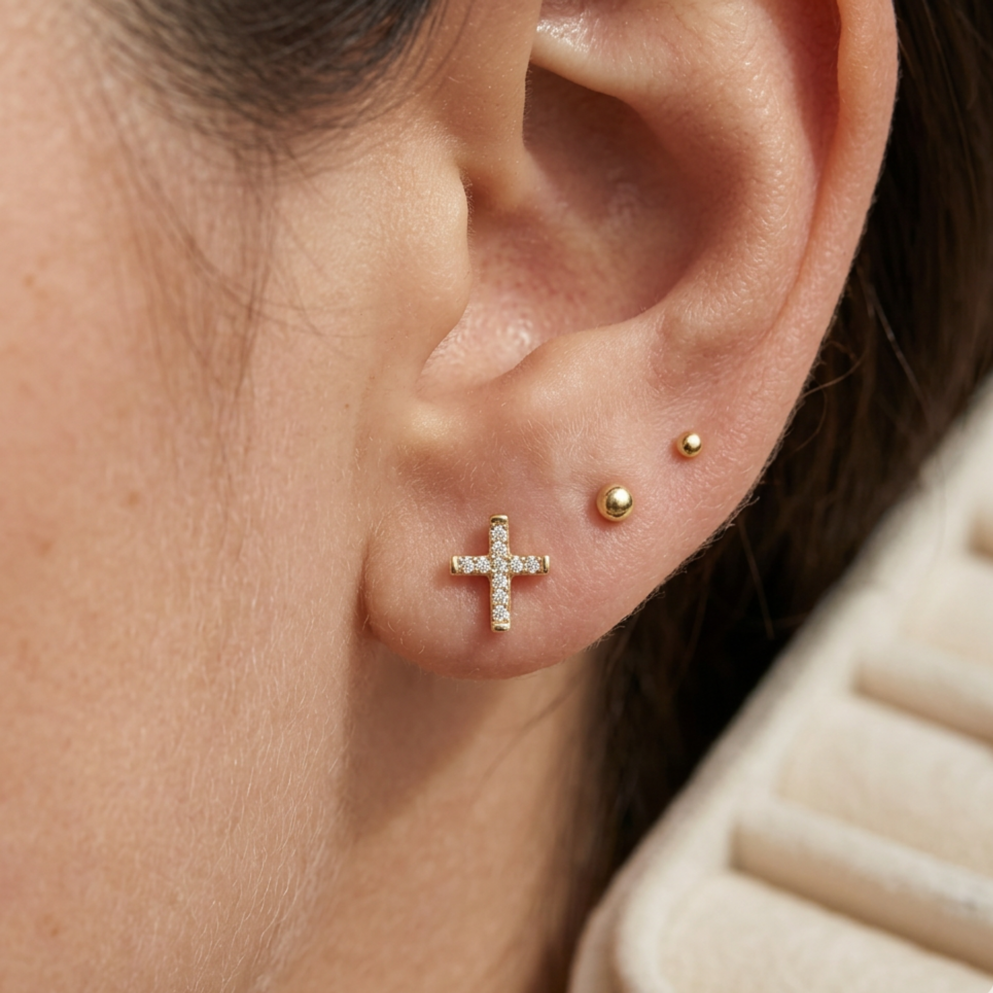 High-polish 14k gold religious earrings with shimmering detail front view