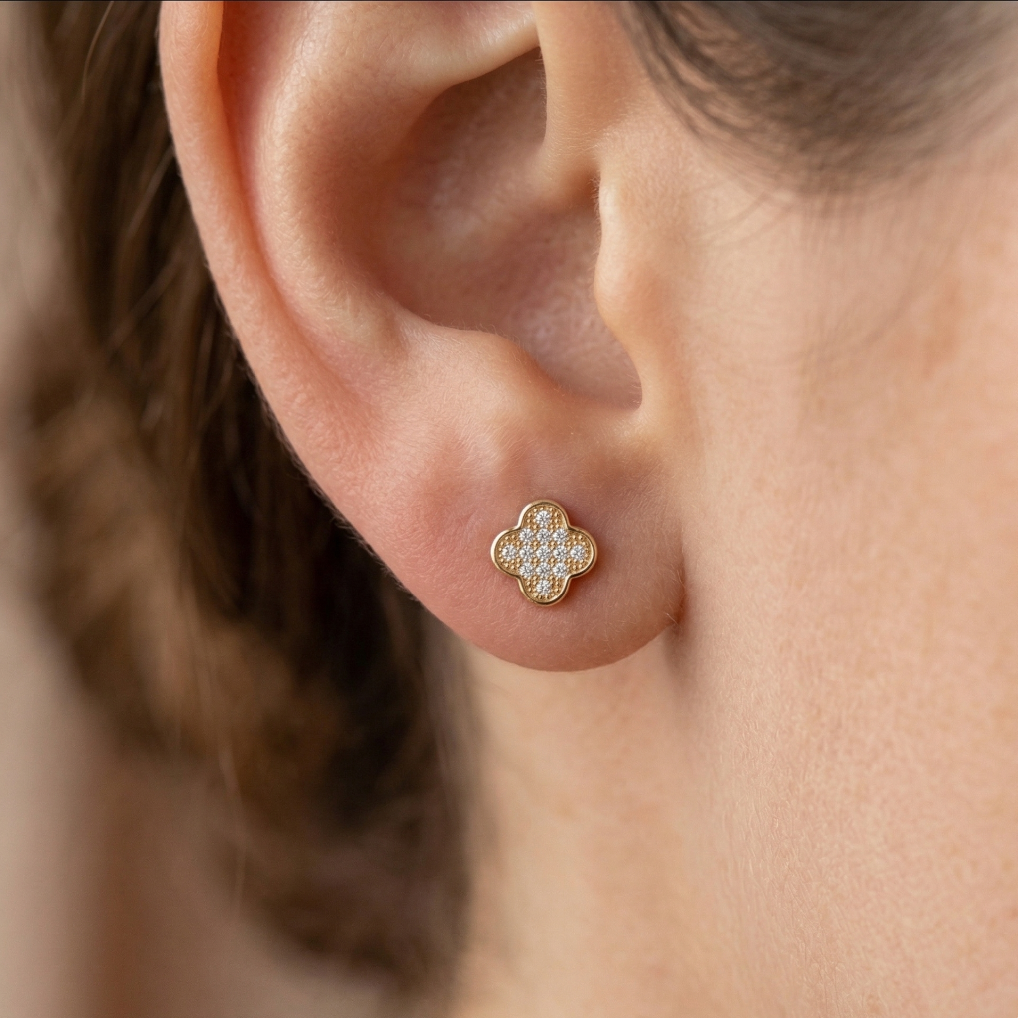 High-polish 14k two-tone gold religious or floral studs with shimmering detail