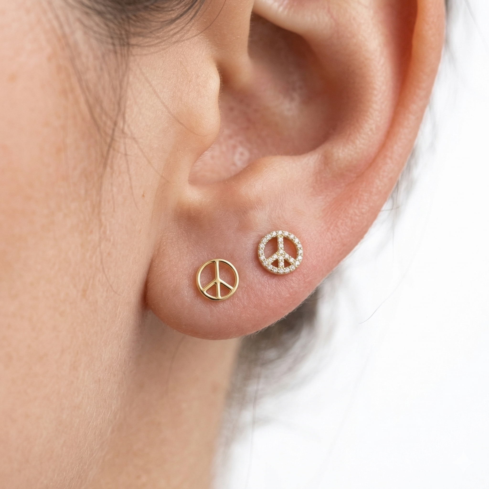 Small 14k yellow gold minimalist peace studs for curated ear mapping