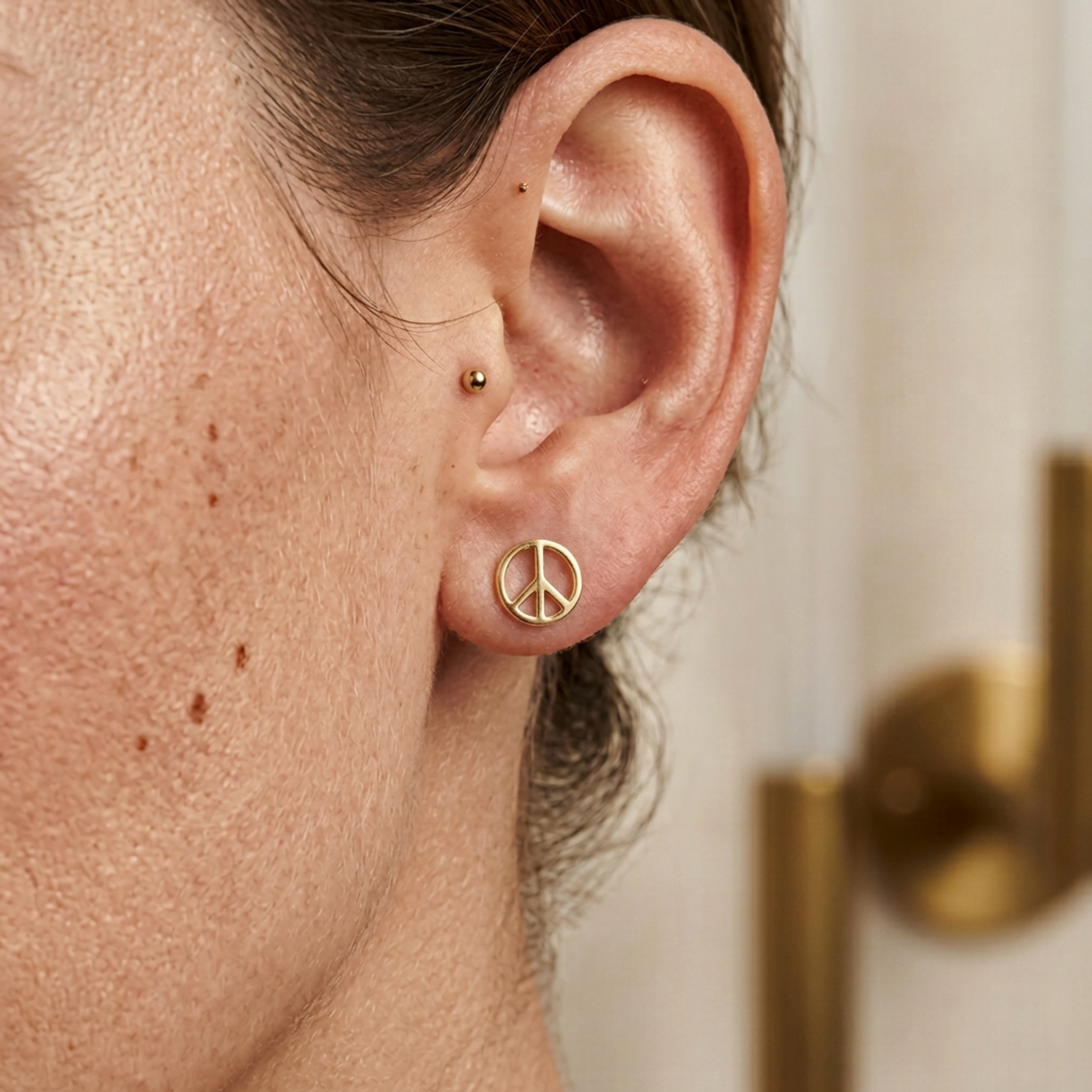 Dainty yellow gold peace symbol studs 8mm height front view