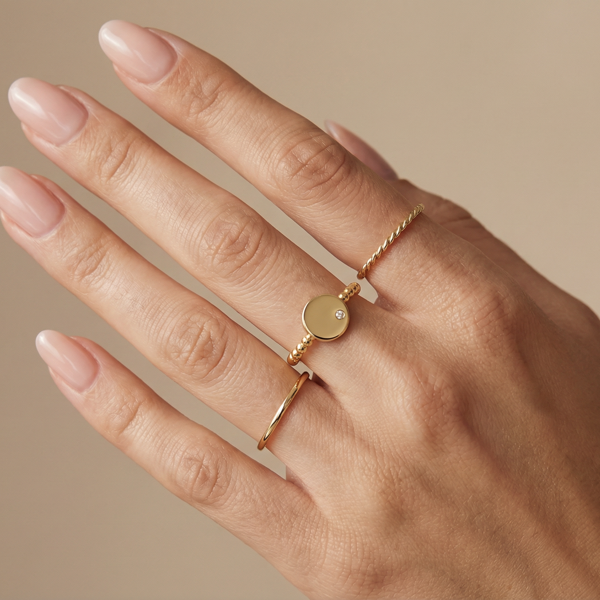 14K solid gold engravable disc ring stacked with other gold rings