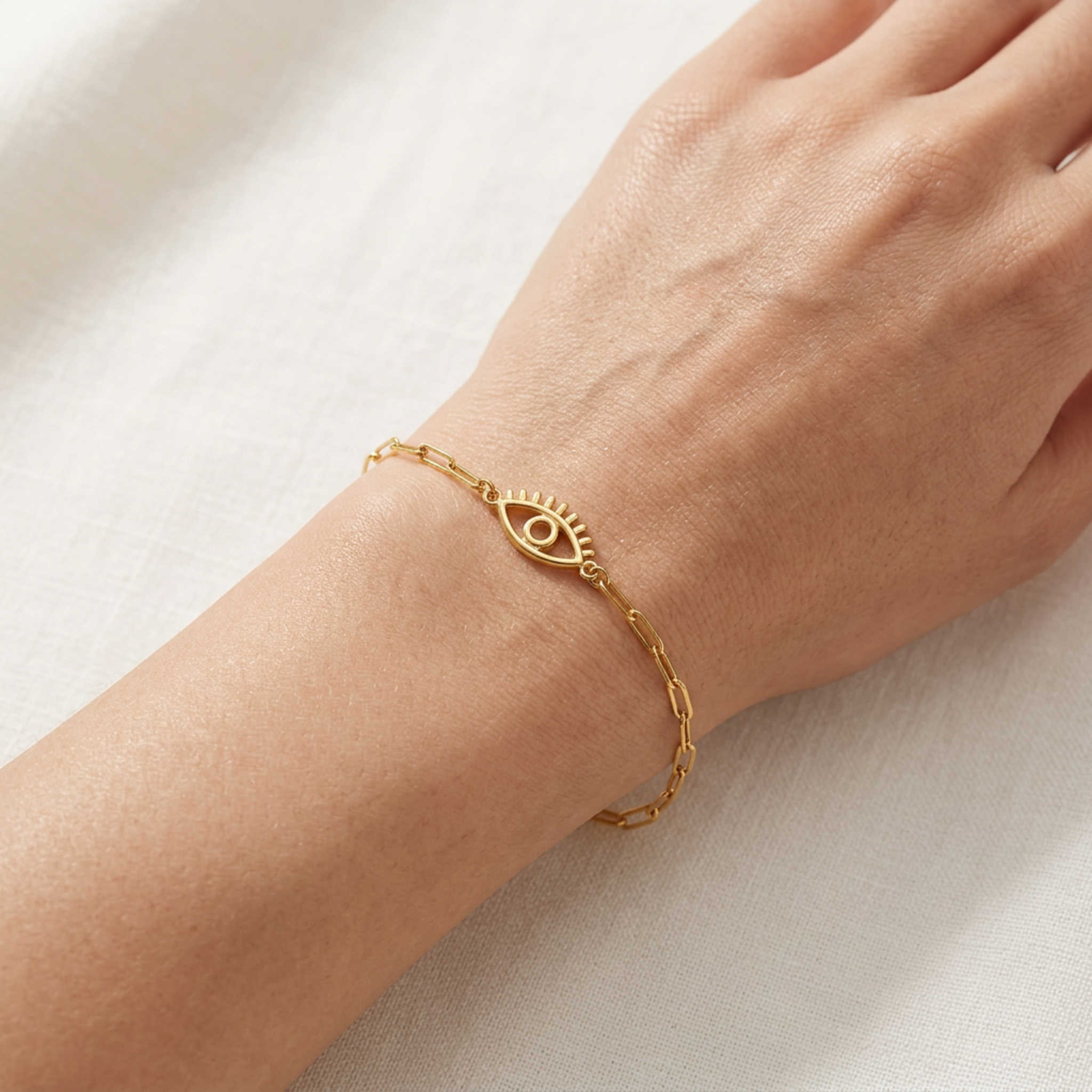 minimal 14k gold eye bracelet worn on wrist, delicate everyday jewelry no gemstone