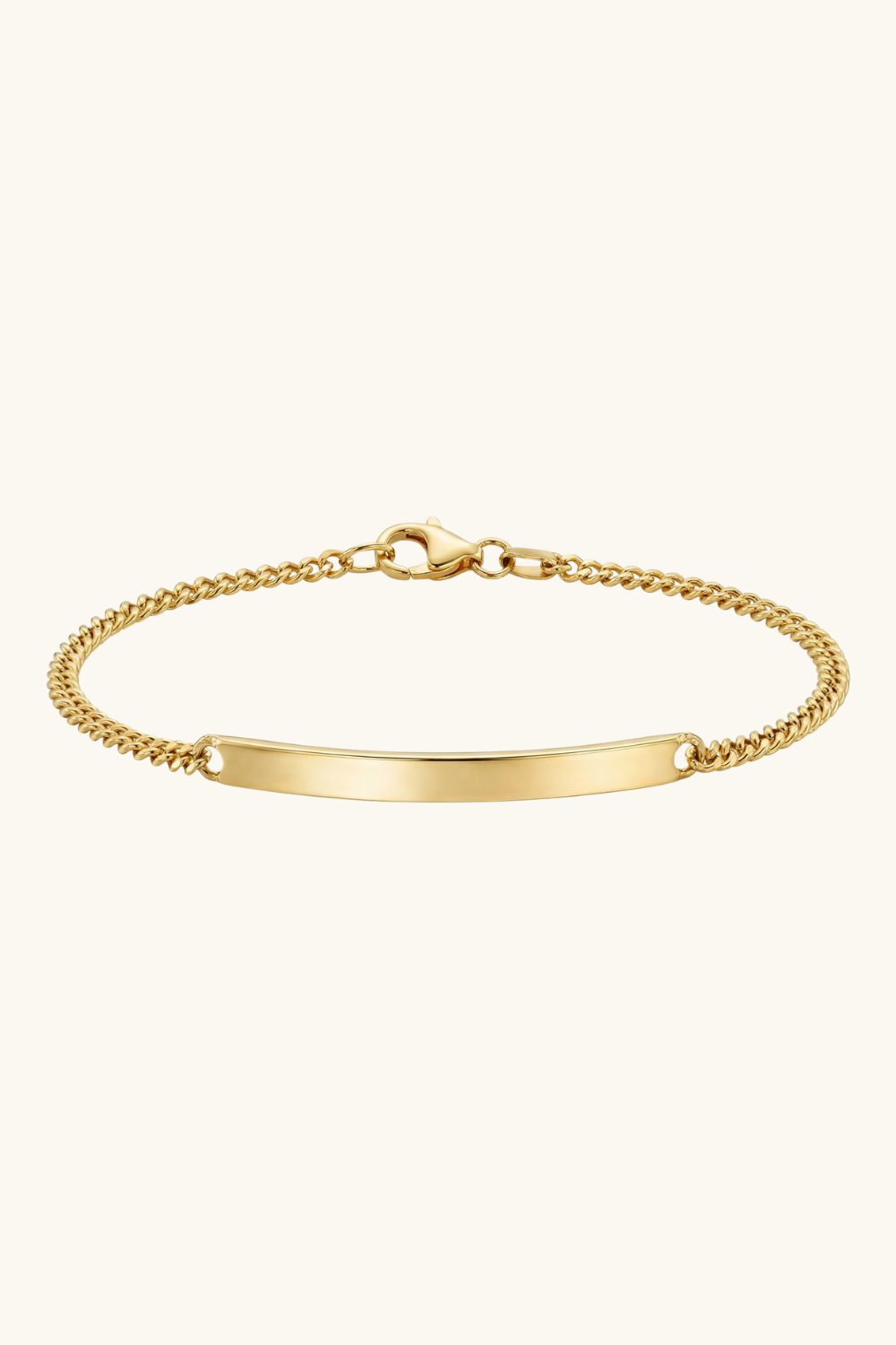 Gold bracelet with a plain tag on a white background