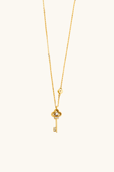 14k solid gold key pendant necklace close up with delicate chain