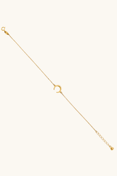 14k solid gold crescent moon bracelet on female wrist, dainty adjustable chain jewelry