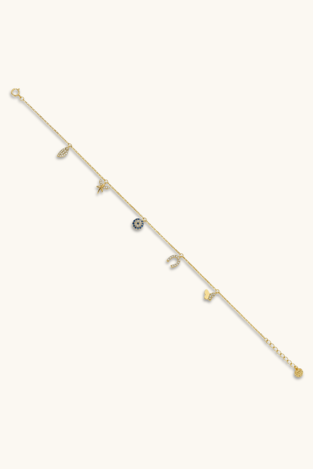 Delicate gold bracelet with small gemstones on a white background