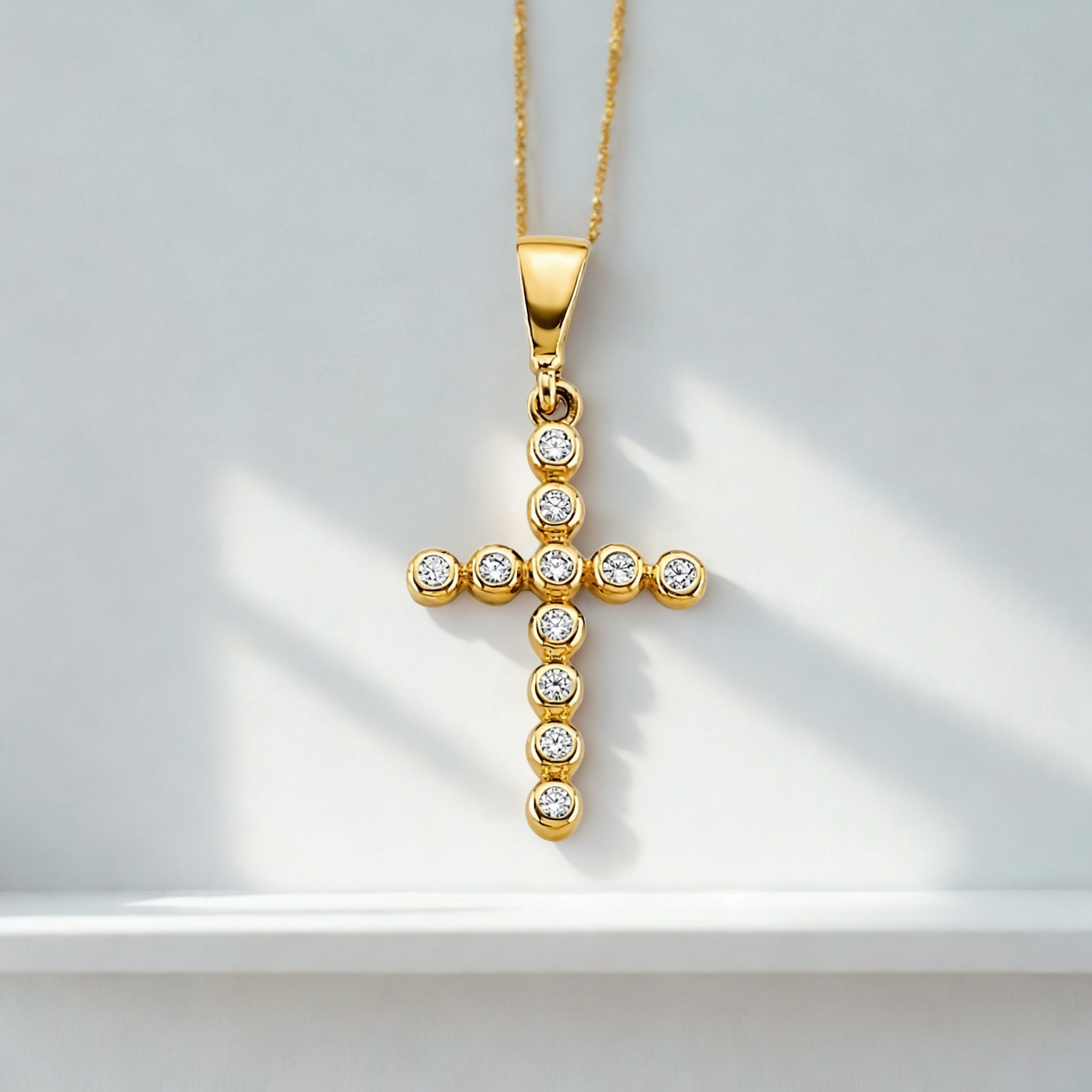 Elegant sparkling cross charm for women on white background