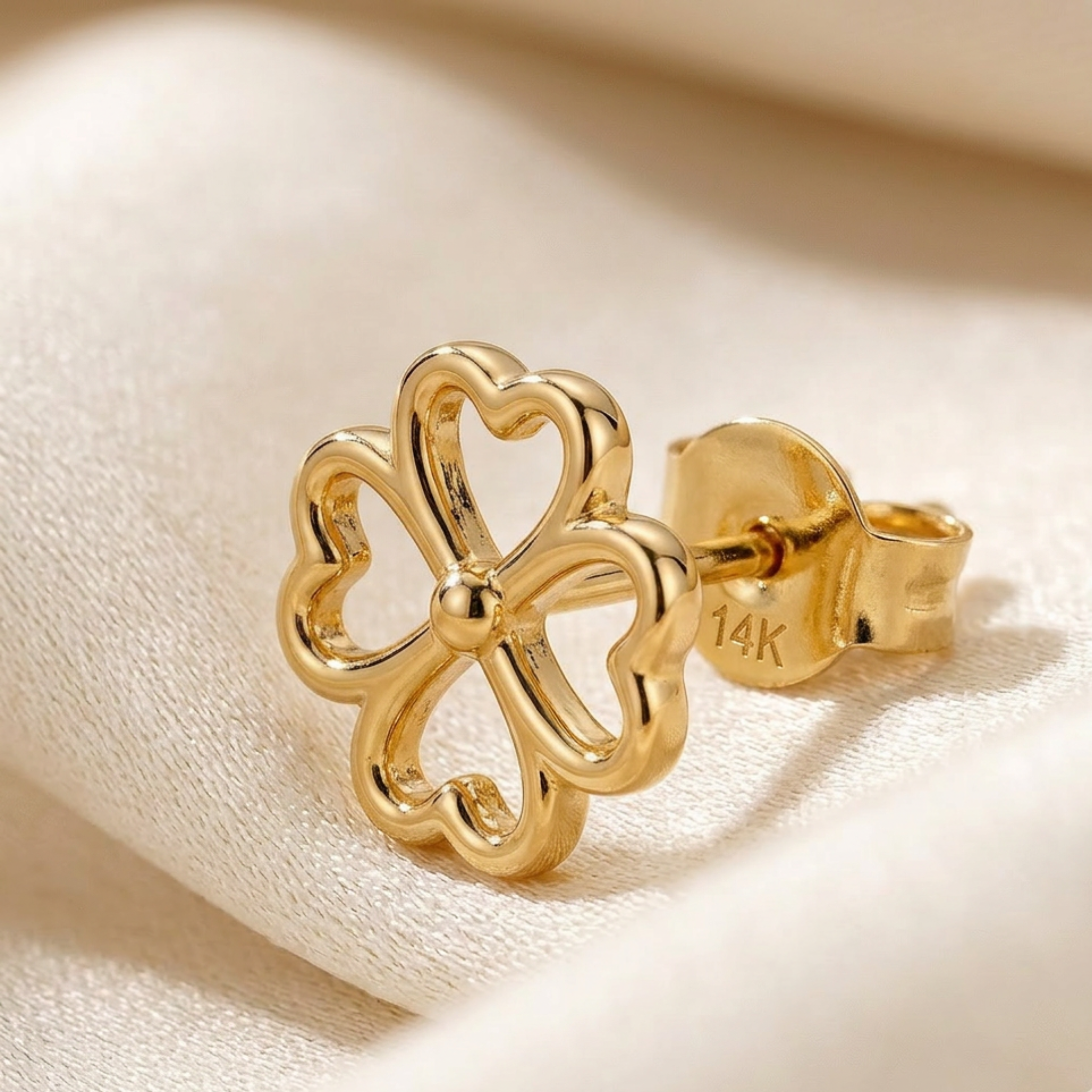 Small 14k yellow gold four leaf clover studs for curated ear