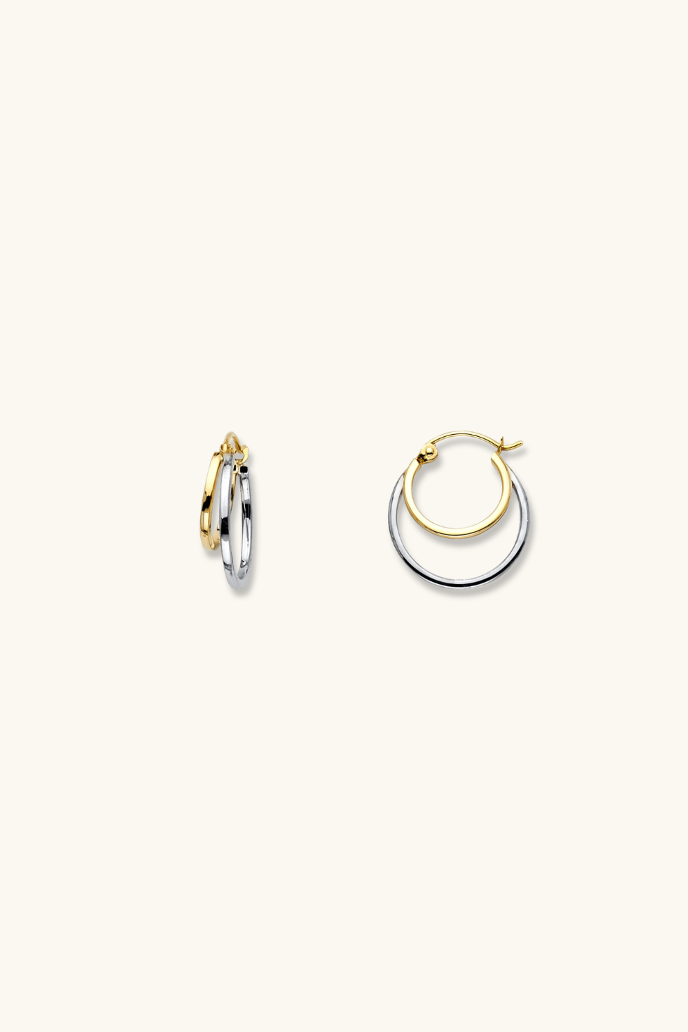 Pair of gold and silver hoop earrings on a white background